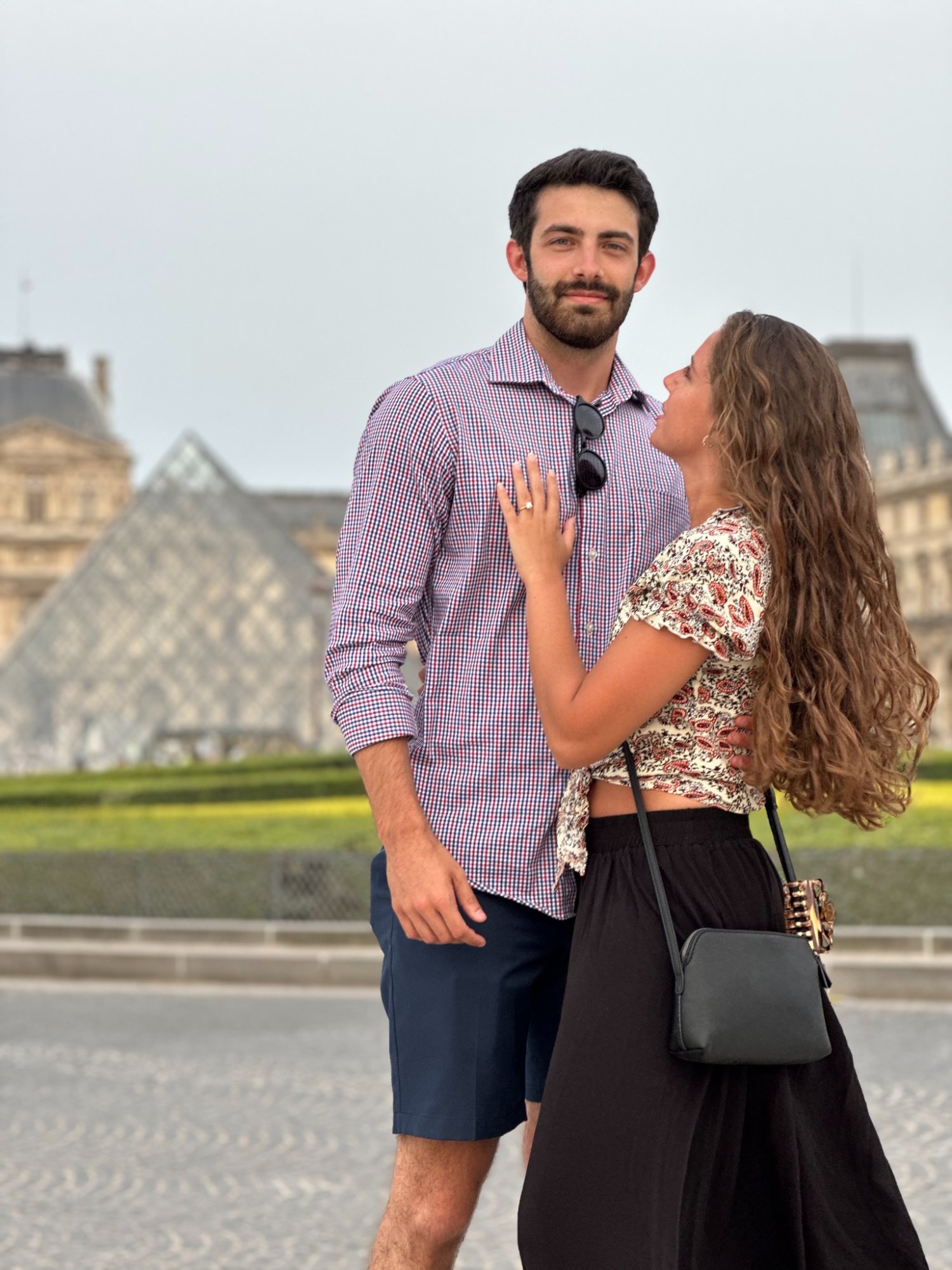 Couple at the Louvre pyramid in Paris